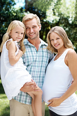 Buy stock photo A happy family of three smiling while outside in a garden - Portrait