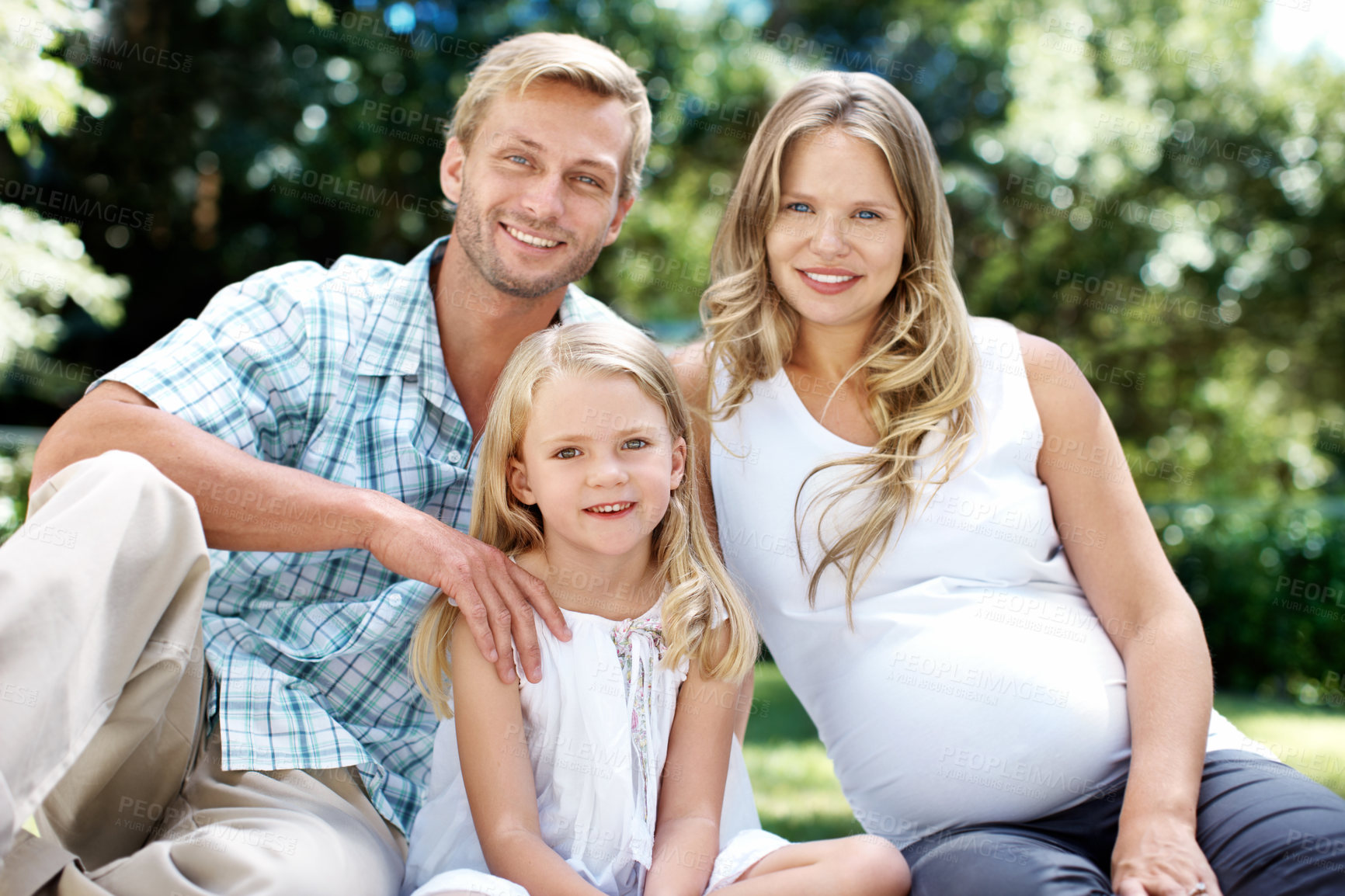 Buy stock photo Portrait, parents and relax in nature with child, love and summer holiday for bonding together. Smile, father or pregnant woman at park with daughter, connection and weekend break for family vacation