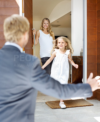 Buy stock photo Cute little girl running towards her father as he arrives home from work