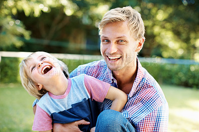Buy stock photo Cute little boy playing in a garden with his dad during the summertime