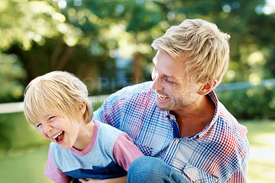 Buy stock photo Cute little boy playing in a garden with his dad during the summertime