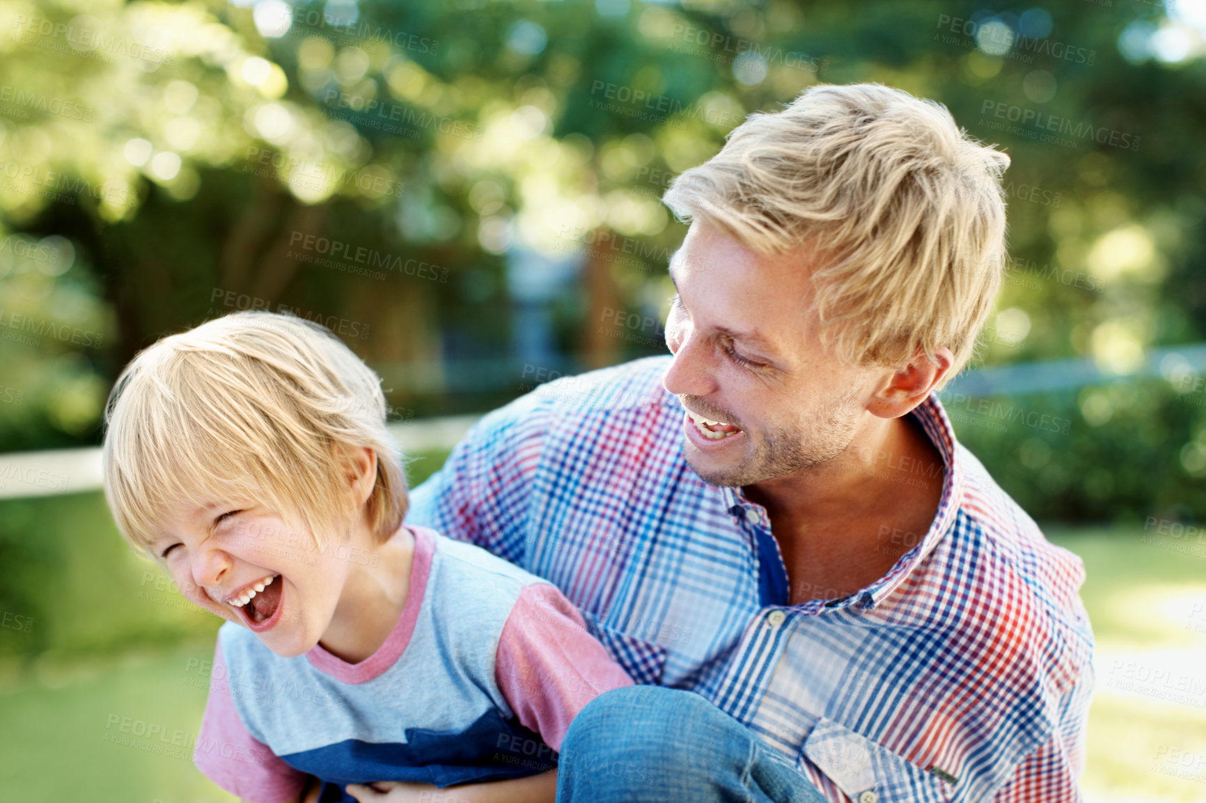 Buy stock photo Laugh, father and kid with playing at park for family bonding, funny holiday outing and support. Trust, happy man and carry boy outdoor for relationship development, playful and dad joke on weekend