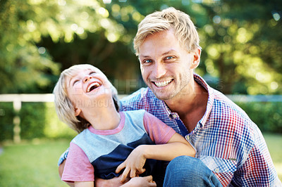 Buy stock photo Cute little boy playing in a garden with his dad during the summertime