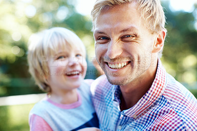 Buy stock photo Cute little boy playing in a garden with his dad during the summertime