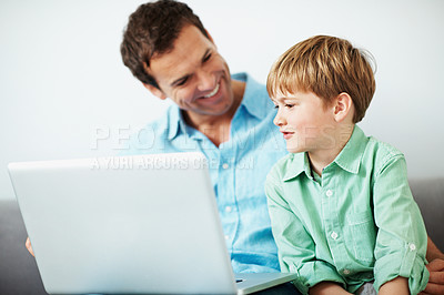 Buy stock photo Father, kid and talk in house with laptop, play knowledge game and support for child development. Happy, man and son in living room with computer, educational gaming and learning skills for growth.