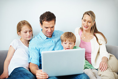Buy stock photo Family, online and children with laptop in lounge, happy people or watching film on website in home. Streaming, movies and parents with kids in living room, man and woman with tech for entertainment