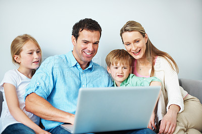 Buy stock photo Family, laugh and children with laptop in lounge, happy people and watching film on website in home. Streaming, movies and parents with kids in living room, man and woman with tech for entertainment