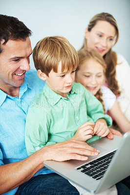 Buy stock photo Laptop, family and happy father with child for educational game, bonding and development in home. Sibling, parents and computer for learning at house with smile, teaching kid and reading story