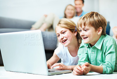 Buy stock photo Kids, siblings and play in home with laptop, educational game and bonding with parents supervision. Happy, children relax and online gaming in living room with computer, knowledge and entertainment.