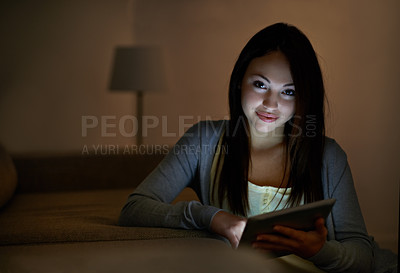 Buy stock photo A gorgeous teenage girl illuminated by her digital tablet