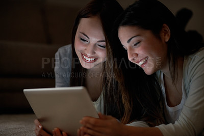 Buy stock photo Closeup of two teenagers playing games on a touchscreen