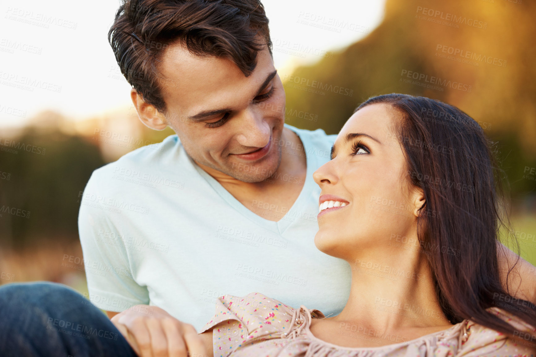 Buy stock photo Love, relax and date with couple in park for romance, affection and care together. Summer vacation, honeymoon and relationship with man and woman bonding in nature for support, trust and happiness
