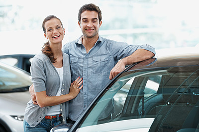 Buy stock photo Portrait, couple and happy at showroom with car, inspection and test drive for transport selection. Smile, people and customer at dealership with vehicle, finance approval and auto purchase decision