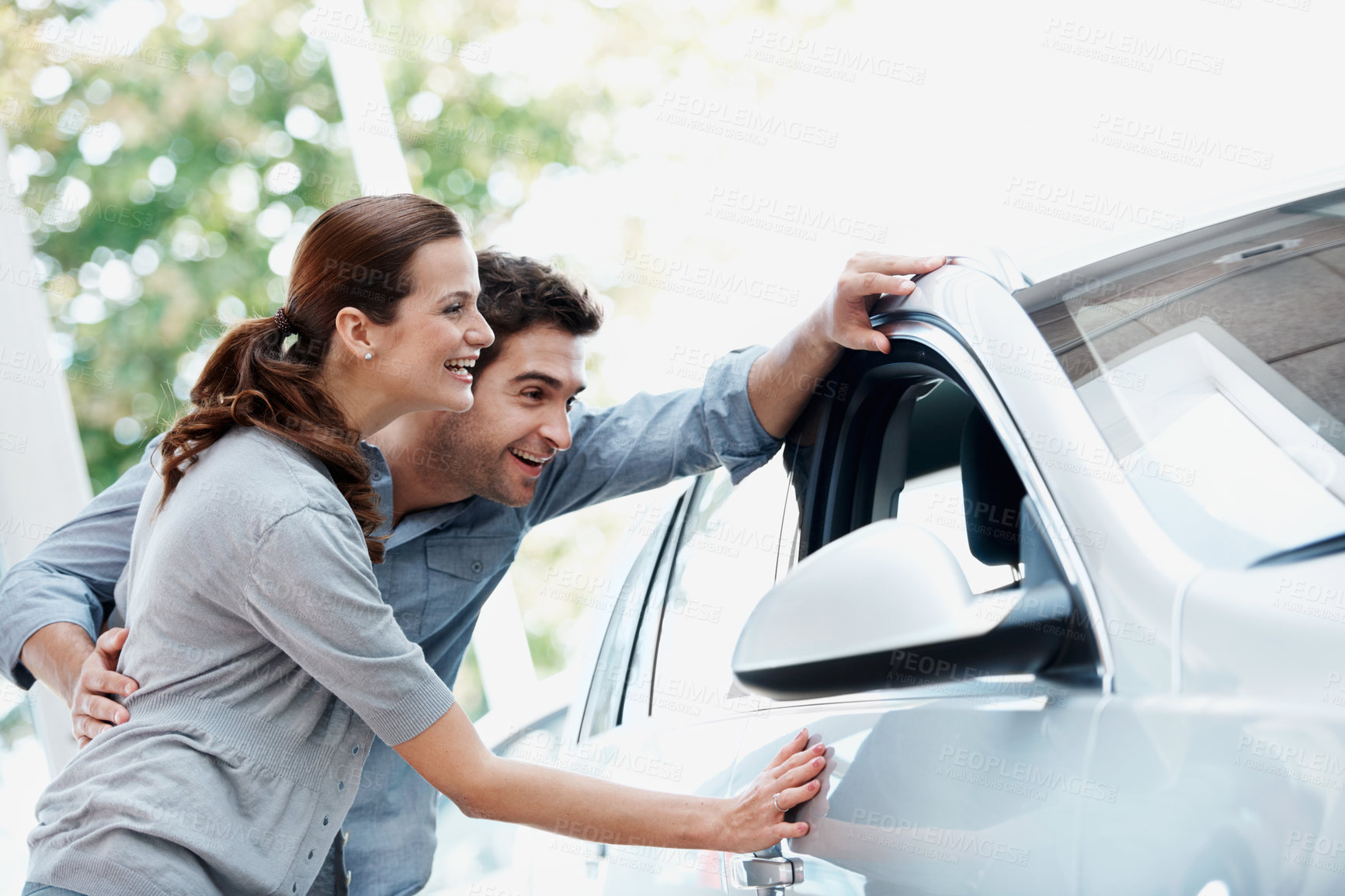 Buy stock photo Car, laughing and shopping with couple in dealership together for decision or purchase. Buying, retail and sale with funny people on showroom floor for consumerism, insurance or vehicle finance