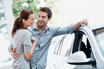 Buy stock photo Car, hug and shopping with happy couple in dealership together for decision or purchase. Buying, laughing and sale with people embracing in showroom for consumerism, insurance or vehicle finance