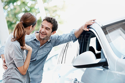 Buy stock photo Car, funny and shopping with couple in dealership together for decision or purchase. Laughing, retail and sale with happy people on showroom floor for consumerism, insurance or vehicle finance