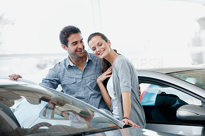 Buy stock photo Car, shopping and talking with couple in dealership together for decision or purchase. Buying, choice and retail sale with happy people on showroom floor for consumerism, insurance or vehicle finance
