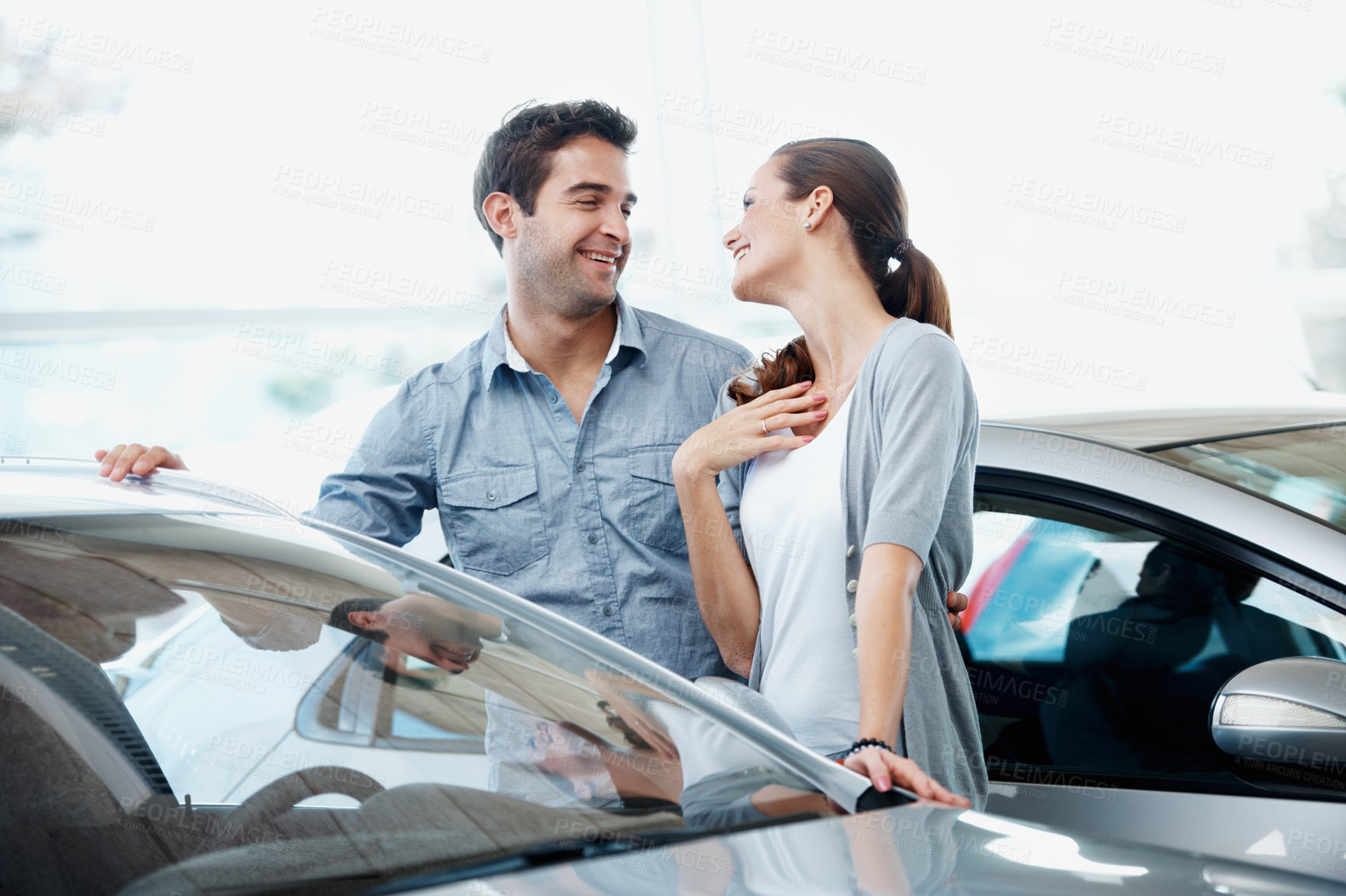 Buy stock photo Car, shopping and smile with couple in dealership together for decision or purchase. Buying, retail and thank you with happy people on showroom floor for consumerism, insurance or vehicle finance
