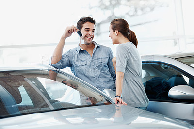 Buy stock photo Happy, couple and surprise in car dealership with keys, transport investment and motor insurance. Married people, shopping together and shock wife in store with new vehicle, keychain and sale promo.