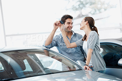 Buy stock photo Couple, smile and purchase in car dealership with keys, transport investment and motor insurance. Married people, shopping together and customer buy new vehicle in store with discount, promo or sale.