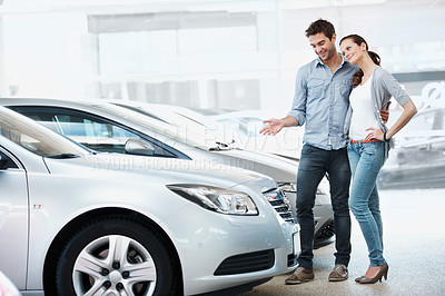 Buy stock photo Happy, couple and shopping in car dealership with support, inspection together and motor insurance. Married people, smile and browsing in store for new vehicle, investment decision and evaluation.
