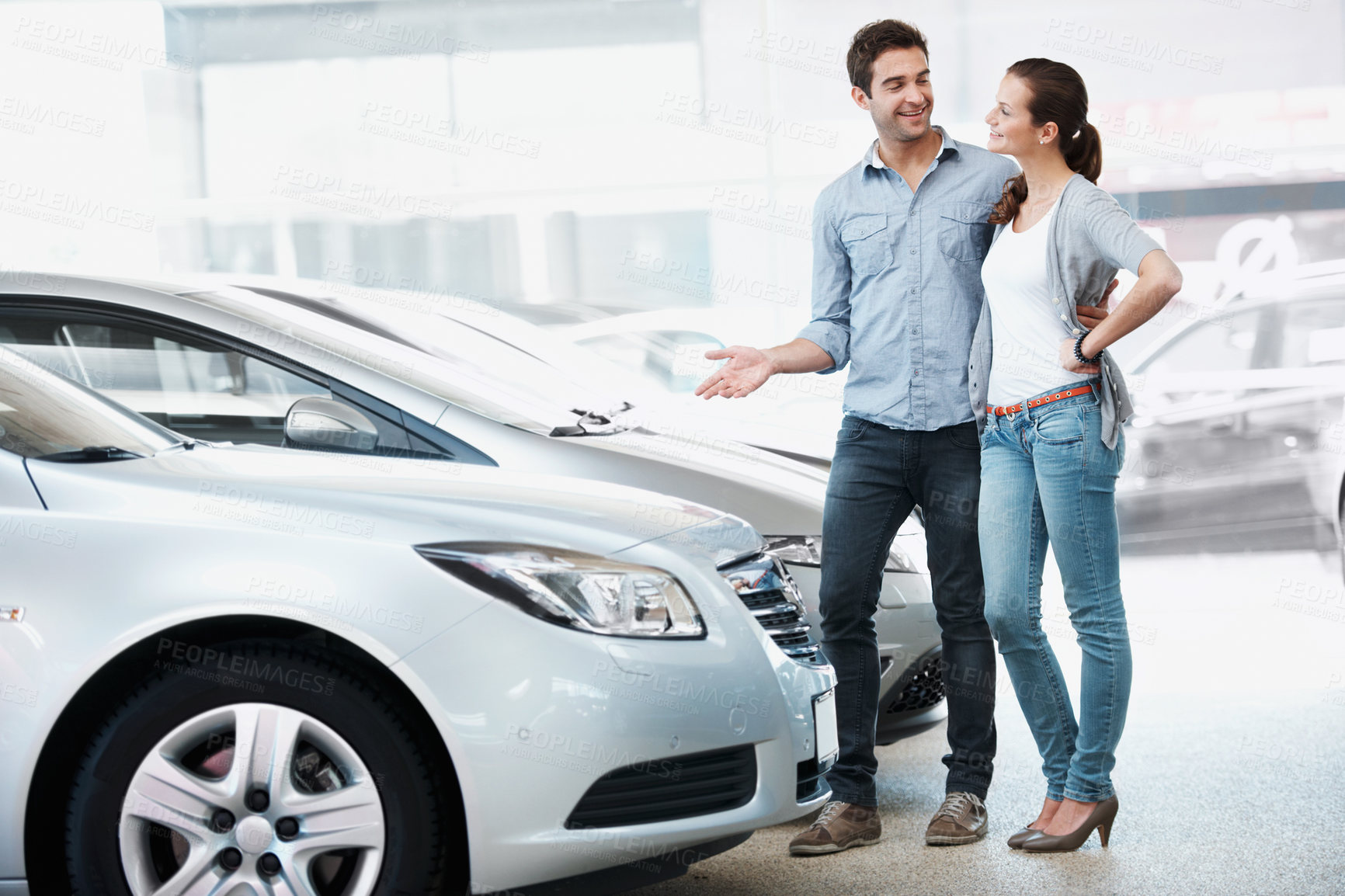 Buy stock photo Happy, couple and browsing in dealership for new car, consider sale promotion and motor insurance. Married people, smile and shopping in store for vehicle, investment decision and retail purchase.