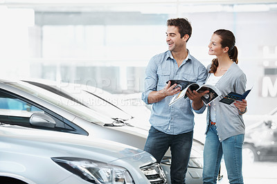 Buy stock photo Selection, car or couple at dealership with pamphlet, inspection or automobile review in showroom. Smile, relationship or people with brochure, choice together or purchase guide in vehicle evaluation