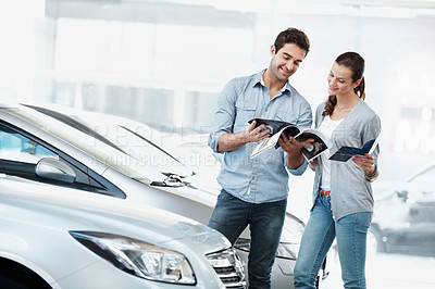 Buy stock photo Review, car or couple at dealership with pamphlet, selection or automobile catalog in showroom. Happy, relationship or people with leaflet, inspection together or purchase info in vehicle evaluation.