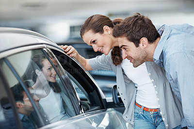 Buy stock photo Car, check and shopping with couple in dealership together for decision or purchase. Buying, retail sale and transport with happy people in showroom for consumerism, insurance or vehicle finance
