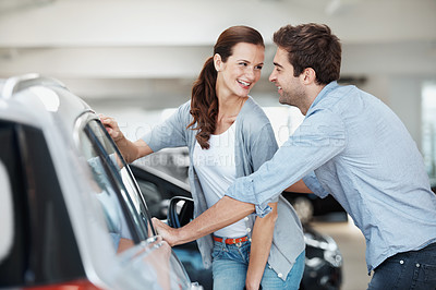 Buy stock photo Love, smile or couple at car dealership with review, decision or automobile selection in showroom. Motor, buyers or people with choice, inspection together or vehicle evaluation in happy relationship