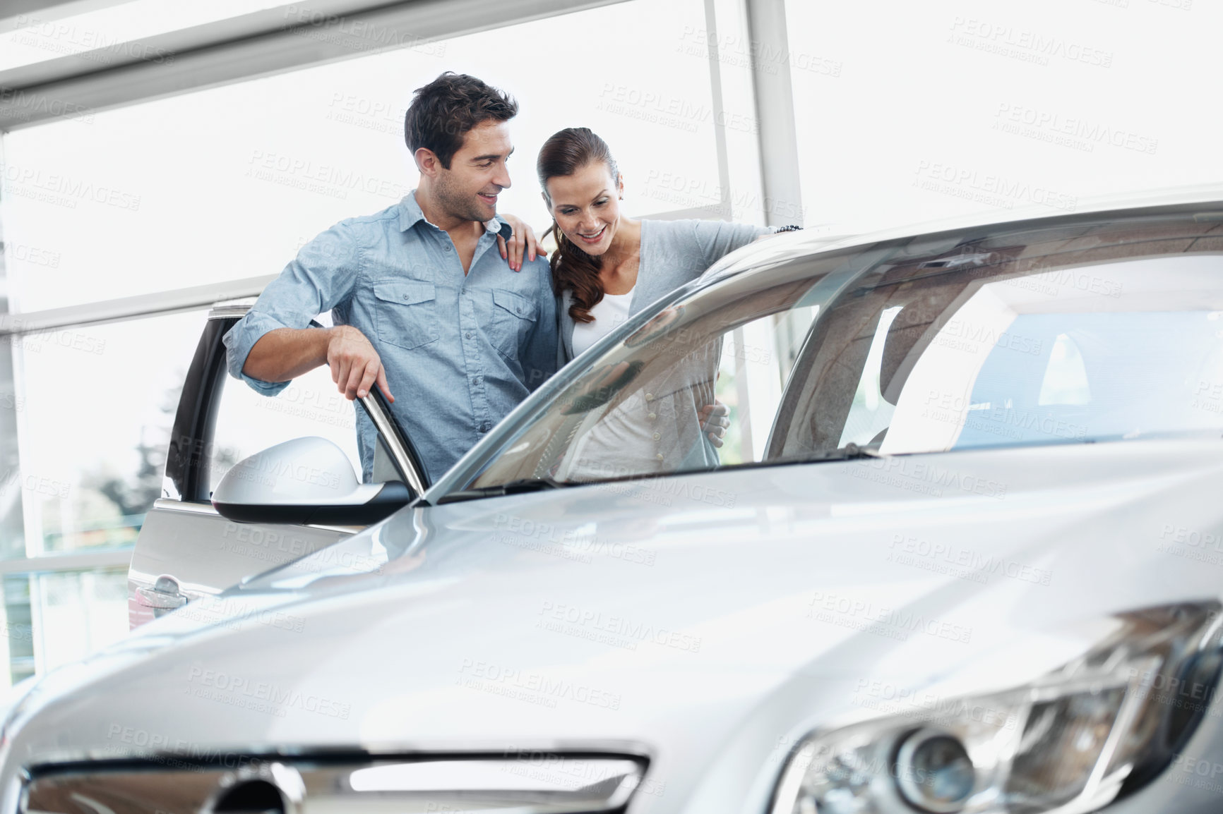 Buy stock photo Door, happy couple and shopping at car dealership, choice and automobile inspection with partner. Showroom, man and woman check vehicle for purchase evaluation, rental or customers with transport