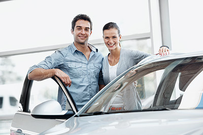 Buy stock photo Portrait, couple and smile at showroom with car, inspection and test drive for transport selection. Happy, people and customer at dealership with vehicle, finance approval and auto purchase decision