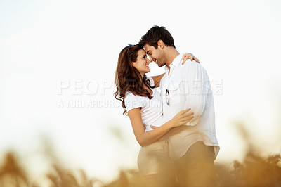 Buy stock photo Love, smile or couple in countryside with hug, partner care or bonding together on summer break. Space, relationship or people with forehead touch, romantic connection or happy moment on outdoor date
