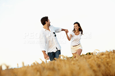 Buy stock photo Love, holding hands and couple in wheat field for bonding, vacation or romance in countryside. Happy, man and woman in nature for weekend trip together with holiday, anniversary and playful travel