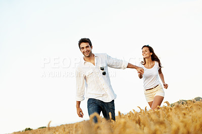 Buy stock photo Excited, couple and holding hands in wheat field for bonding, vacation or romance in countryside. Happy, man and woman in nature for weekend trip together with holiday, anniversary and playful travel