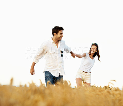 Buy stock photo Smile, couple and holding hands in wheat field for holiday, bonding or romance in countryside. Space, man and woman in nature for weekend trip together with vacation, anniversary and playful travel