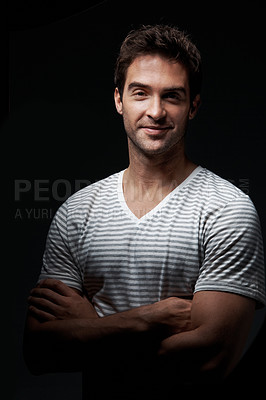 Buy stock photo Studio, portrait or happy man with confidence for fashion, style or mysterious behaviour on a dark background. Smile, male person or clothing with arms crossed or shadow for hidden or secret identity