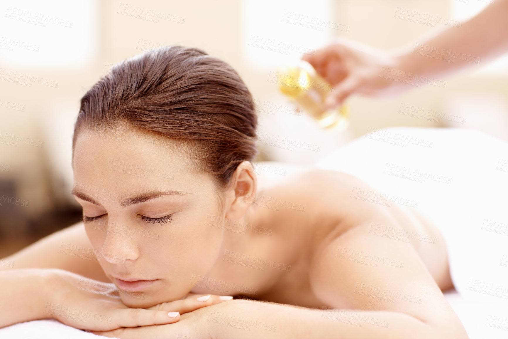 Buy stock photo Woman, relax and back massage at spa with oil, aromatherapy and pamper for muscle stiffness. Person, sleeping and masseuse at retreat with organic serum, blood circulation and therapeutic treatment