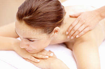 Buy stock photo Calm young woman lying on a spa bed and receiving a massage