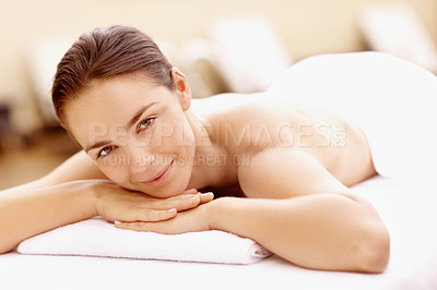 Buy stock photo Relaxed young woman lying on a spa bed and smiling while waiting for a massage