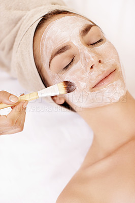 Buy stock photo Pretty young woman receiving a face mask treatment at a spa