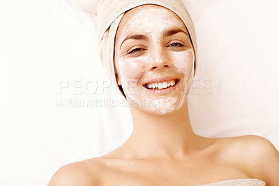Buy stock photo Smiling young woman enjoying a face mask treatment at a spa