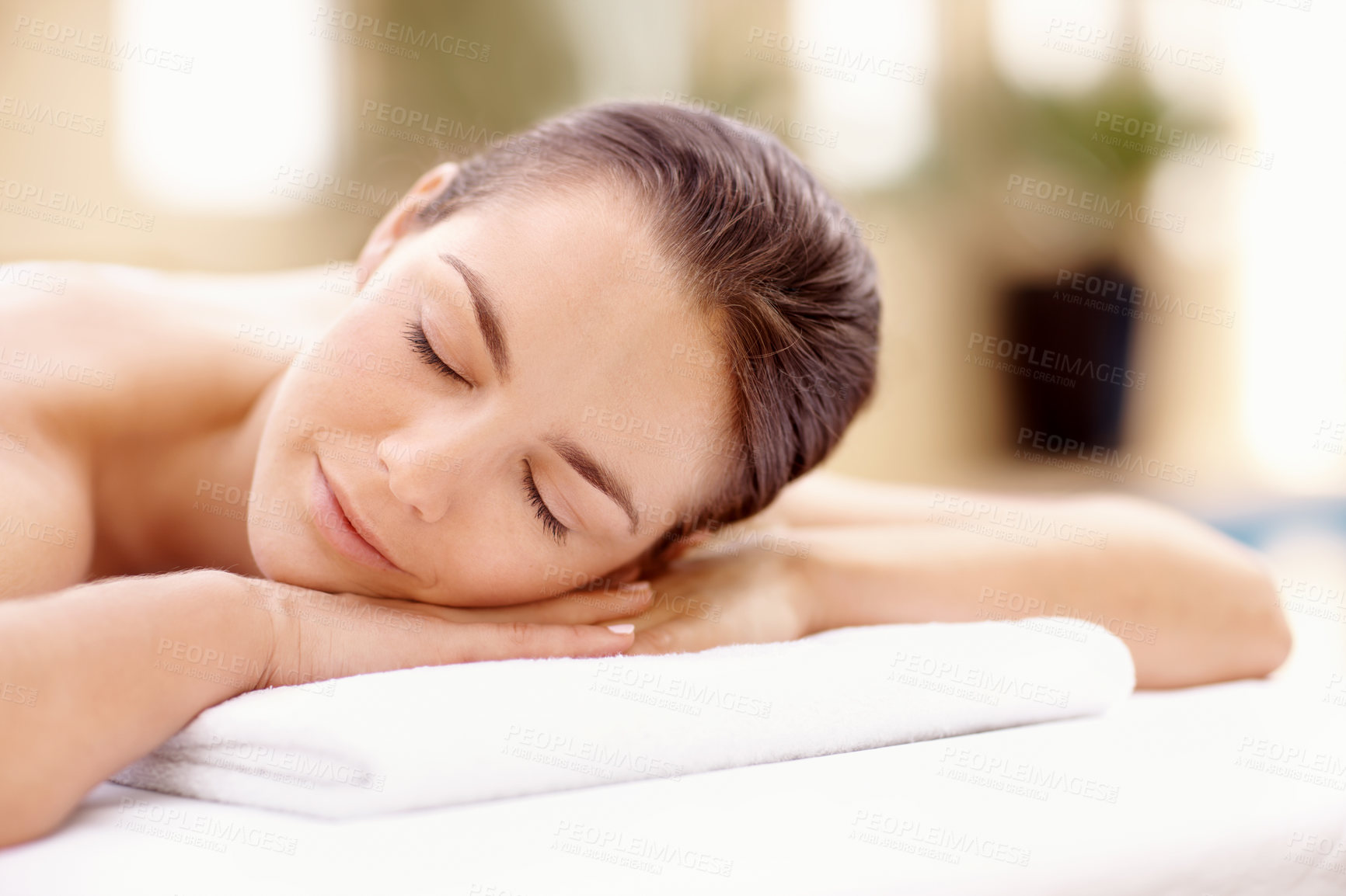 Buy stock photo Zen, woman and relax on massage table at spa for luxury pamper, muscle therapy and happy. Hospitality, calm girl and waiting at resort for wellness treatment, service and body care for stress relief
