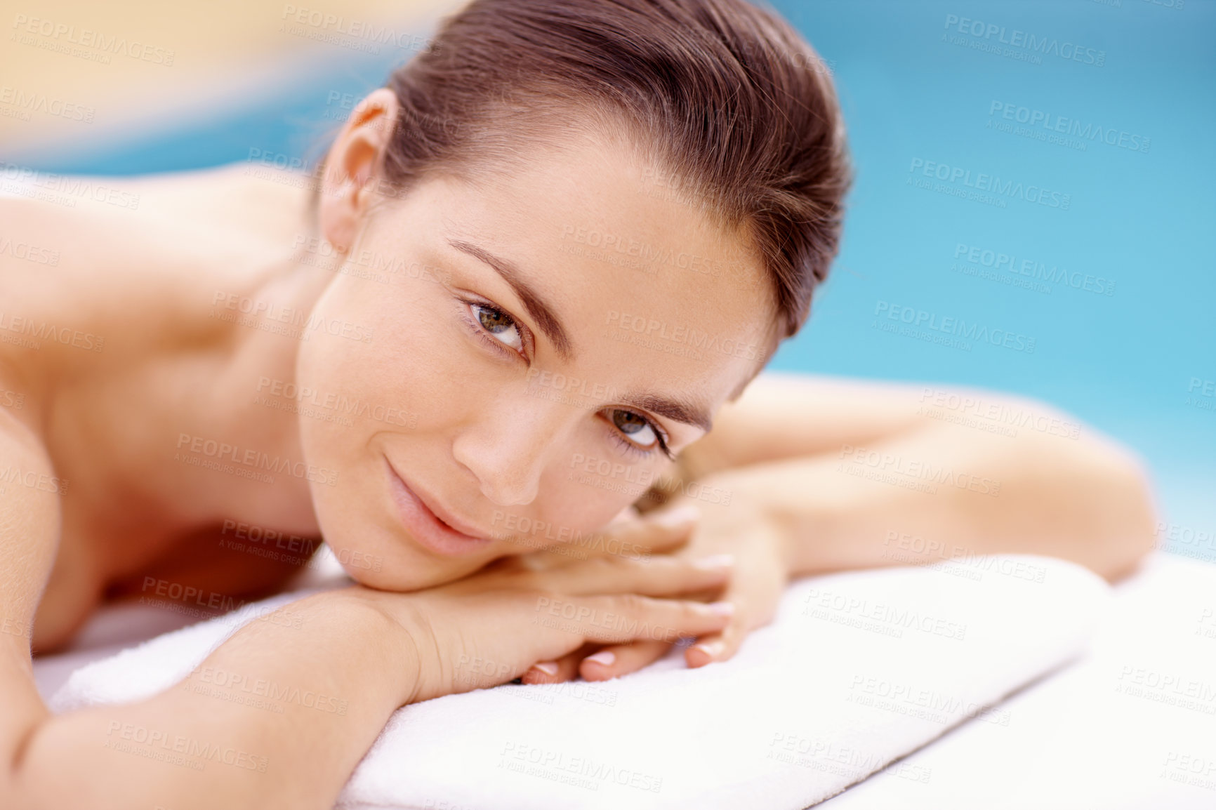 Buy stock photo Relax, woman and portrait on massage table at spa for luxury pamper, muscle therapy and happy. Hospitality, girl and waiting at resort for wellness treatment, body care and stress relief at poolside