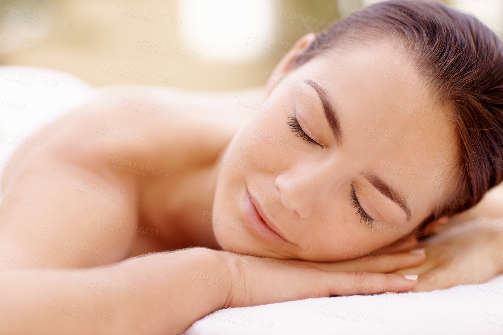 Buy stock photo Calm, woman and relax on massage table at spa for luxury pamper, muscle therapy and selfcare. Hospitality, person or rest at wellness resort for holistic treatment, body care or zen for stress relief