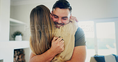Buy stock photo New home, happy couple and hug with key, property investment or support with partner in living room. Real estate goal, man and woman embrace in dream house, smile and purchase with mortgage success