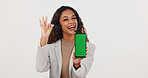 Okay sign, phone and woman with green screen for call center, contact us and space for news. Mockup, happy and person with headset, cellphone or approve emoji for customer service on white background