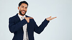 Pointing, space and portrait of business man in studio for real estate offer, presenter and about us. Property showcase, mockup and opportunity with employee on white background for promotion