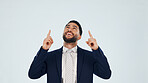 Pointing, space and happy with business man in studio for real estate offer, presenter and about us. Property showcase, mockup and opportunity with employee on white background for promotion