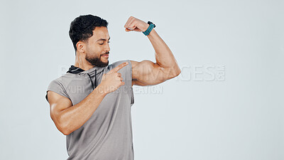 Buy stock photo Man, pointing and flexing bicep for fitness, gym and pride in muscle with results or progress in studio. Personal trainer, strong or power with smile for exercise and bodybuilding on background space